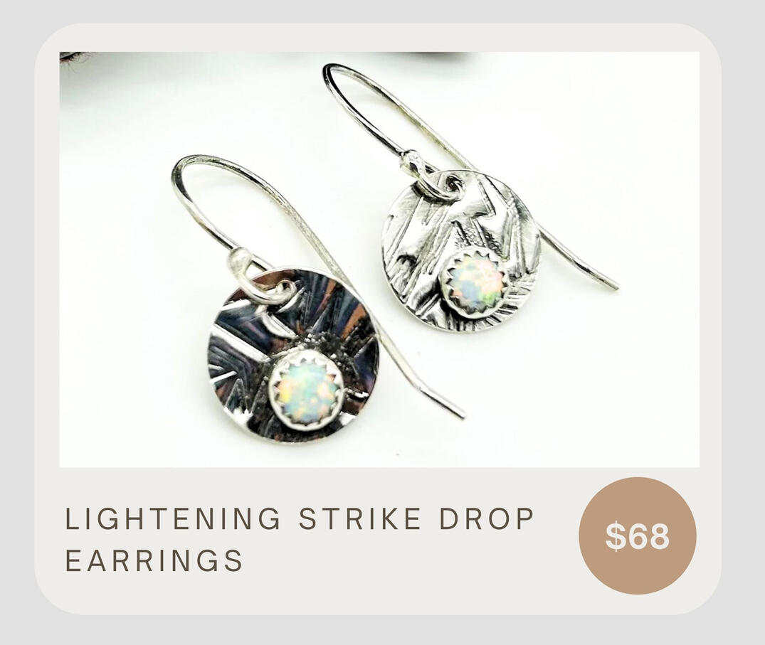 These drop earrings are adorned with stunning Kyocera Opals, fine silver bezels, and sterling silver ear wires.