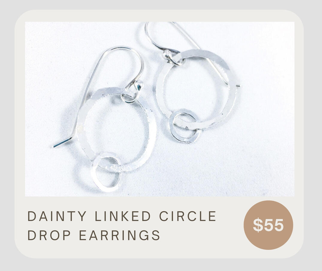 Dainty linked circle drop earrings. Fine silver .999 linked hammered circles Handmade .925 ear wires The large circle is approximately 3/4” wide and the small circle is 1/4” wide. The dangle is 1”. The full drop of the earring is 1 3/8”