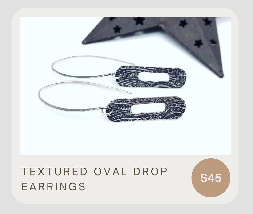 Unique & simple! These stunning earrings feature a textured oval in a drop style earring. Made from sterling silver.