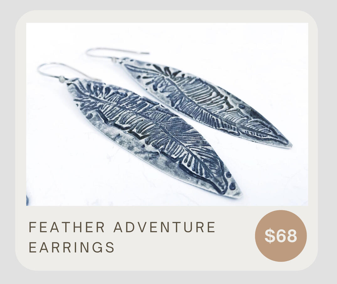 Handmade fine silver feather earrings with asymmetric feather impressions. Handmade artisan earrings. These are made to order and will be similar to the pictures. They dangle about 3 inches and have sterling silver ear wires.