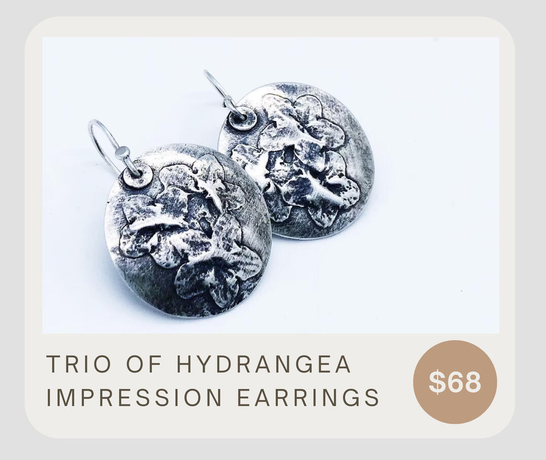 The flower design is an impression of hand pressed actual flowers. They are featured on a silver domed disc with handmade ear wires. The earrings measure almost 1” in diameter and the flowers are three dimensional.