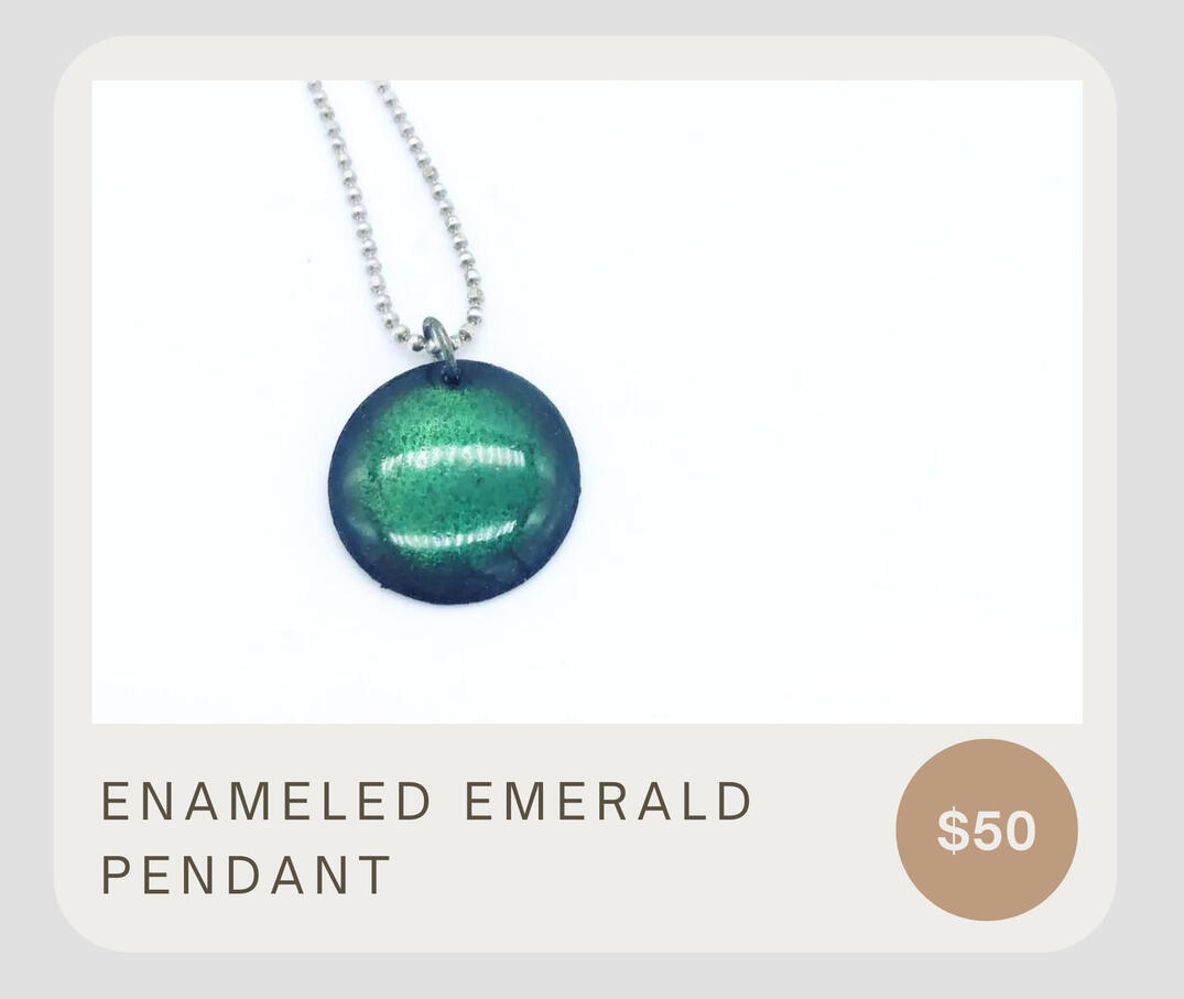 These pendant necklace features a handmade copper disc with green enamel overlay on a sterling silver diamond cut ball chain.