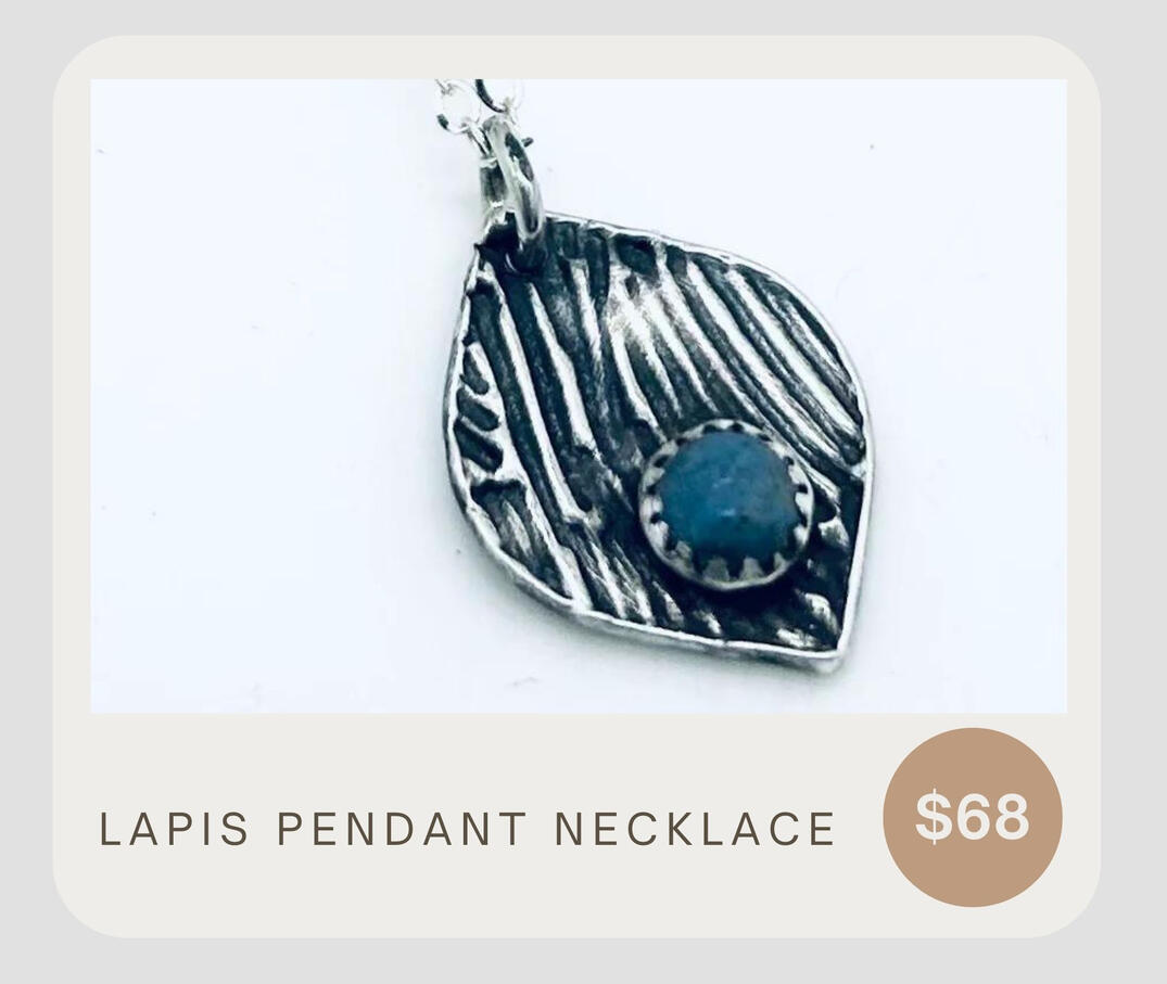 This sterling silver necklace boasts a fine silver pendant and Lapis gemstone adorned with a rustic patina design. 18&quot; chain.